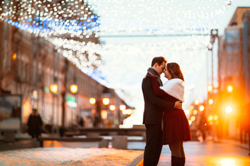 young couple on the background of the street in lanterns