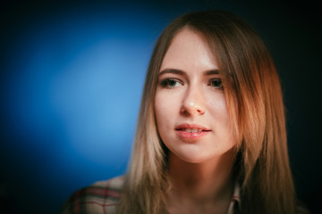 Fototapeta premium portrait smiling girl on blue background in studio