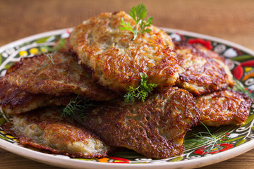 Vegetable fritters, latkes, draniki, hash browns - popular dish in many countries. Potato pancakes