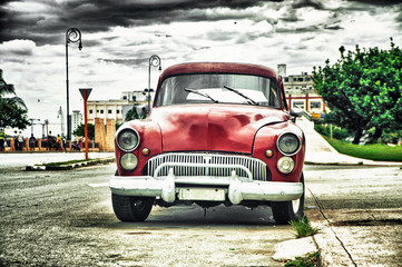 old american car parked on street of habana