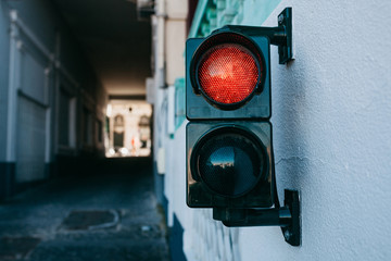 A traffic light on the wall in Lisbon in Portugal