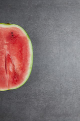 Fototapeta na wymiar top view of fresh watermelon cut half on grey concrete tabletop