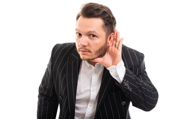 Portrait of business man showing can't hear gesture.