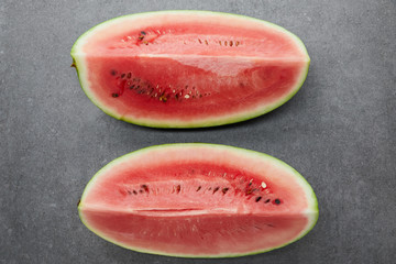 flat lay with arranged watermelon pieces on grey concrete tabletop