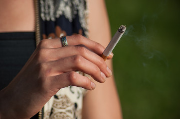 closeup of woman with cigarette in outdoor