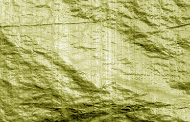 Plastic material uneven surface in yellow color.
