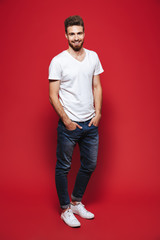 Full length portrait of a handsome young bearded man