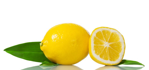 Bright yellow lemon with green leaves and piece of fruit isolated on white