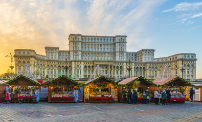 Christmas market and decorations in center of Bucharest, Parliament building in background, Romania