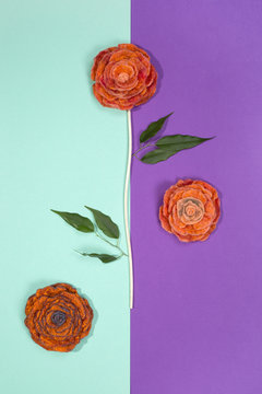 Three brooches of fulled wool in the form of a flower on a colored background