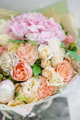 beautiful spring bouquet. flower arrangement with hydrangea and peonies. Color light pink. The concept of a flower shop, a small family business