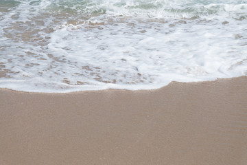 HDR shot of sea shore with wave and white sand during summer day in thailand (selective focus and...