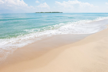 HDR shot of sea shore with wave and white sand during summer day in thailand (selective focus and...