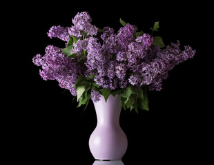 Luxury bouquet of lilac in vase isolated on black
