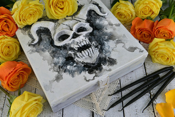 Witch box with devil face, black candles and yellow roses. Vintage mystic background, esoteric and occult Halloween concept