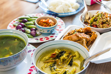 Includes a set of Thai dishes on the table.