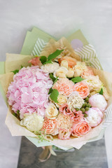 beautiful spring bouquet. flower arrangement with hydrangea and peonies. Color light pink. The concept of a flower shop, a small family business