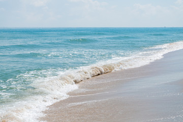 HDR shot of sea shore with wave and white sand during summer day in thailand (selective focus and...