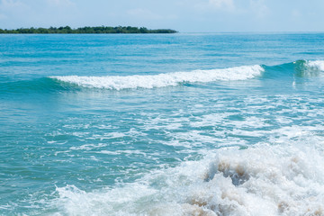 HDR shot of sea shore with wave and white sand during summer day in thailand (selective focus and white balance / color tone shift )