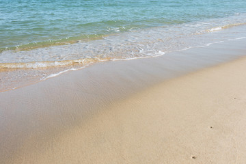 HDR shot of sea shore with wave and white sand during summer day in thailand (selective focus and white balance / color tone shift )