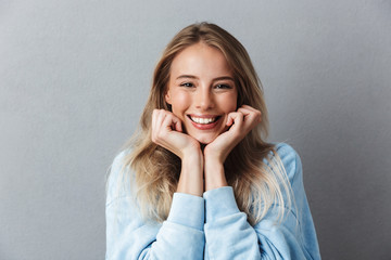 Portrait of a lovely young girl in blue sweatshirt
