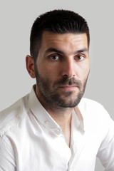 Obraz premium Portrait of young attractive bearded man, studio headshot