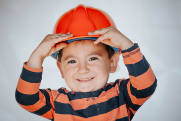 Portrait of little boy in headpiece. Concept of real estate and engineering