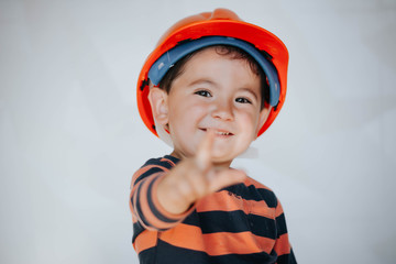 Portrait of little boy in headpiece. Concept of real estate and engineering