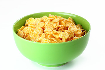 cornflakes in wooden bowl on table