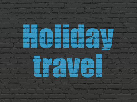 Vacation concept: Painted blue text Holiday Travel on Black Brick wall background