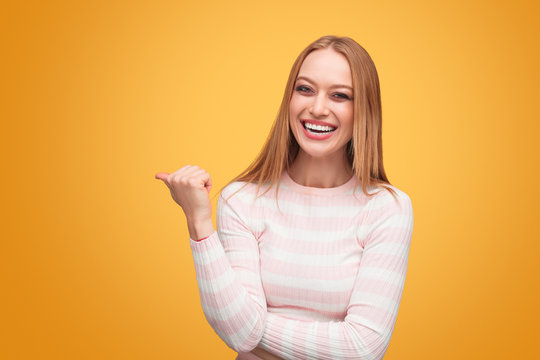 Cheerful Blond Woman Pointing Away