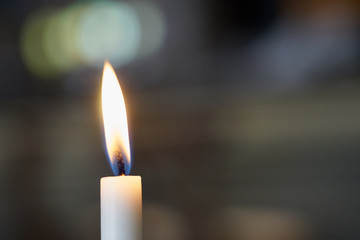 Candle with blurred background. Copy space for text.