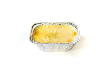 baked cheese in aluminum foil tray on white background