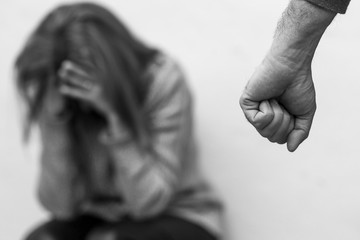 Man beating up his wife illustrating domestic violence