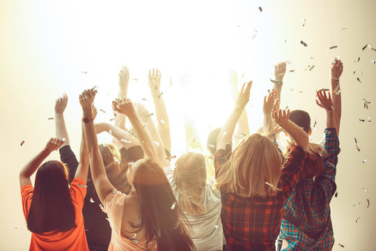 Nightlife and disco concept. Young people are dancing in club.