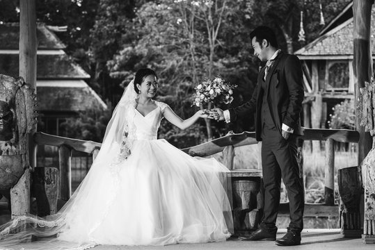 Couple Getting Married Shot Outdoor In A Field With Selective Focus In Black And White