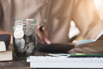 Accountant calculating  the Saving Account Book and Statement of financial statements at home. Accountancy Concept.