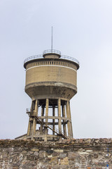 Vertical close-up shot of old reinforced pale yellow colored concrete water tank in Izmir at Turkey