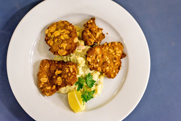 Fried chicken meat with nuts and salad