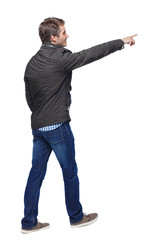 Naklejka premium Back view of a man in a warm jacket walking with a pointing hand.