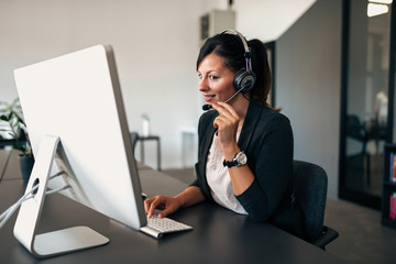 Lovely businesswoman using headset.