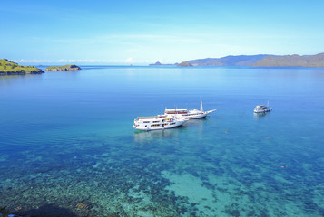 Fototapeta na wymiar Tourist boats at Gili lawa island with a clear blue sea, Flores, Indonesia .