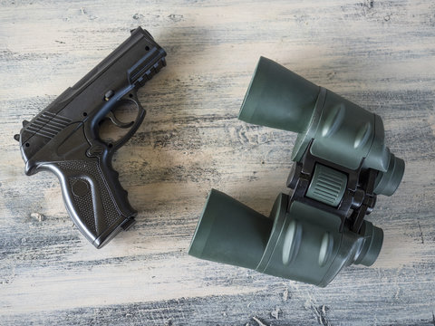 Pistol and binoculars