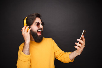 Trendy man taking selfie in sunglasses