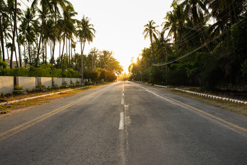 Sunset and peaceful scene of empty two lanes street in Thandwe, Myanmar