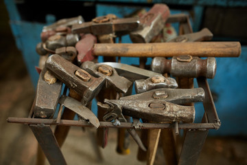 Obraz na płótnie Canvas Working metal tools in blacksmith's workshop, close-up, selective focus, nobody