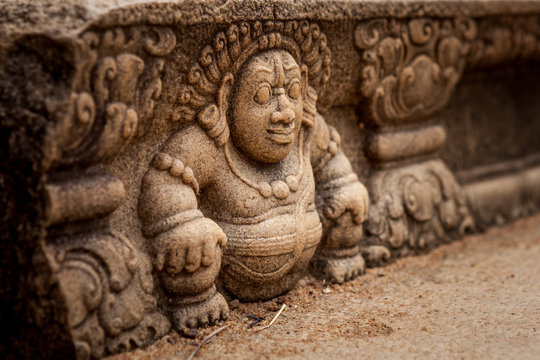 Sri Lanka, Anuradhapura. Mythological character on a stone wall of a buddhist temple close-up