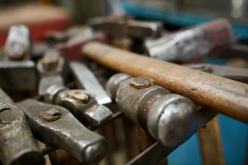 Working metal tools in blacksmith's workshop, close-up, selective focus, nobody