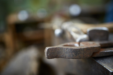 Working metal tools in blacksmith's workshop, close-up, selective focus, nobody