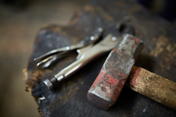 Working metal tools in blacksmith's workshop, close-up, selective focus, nobody